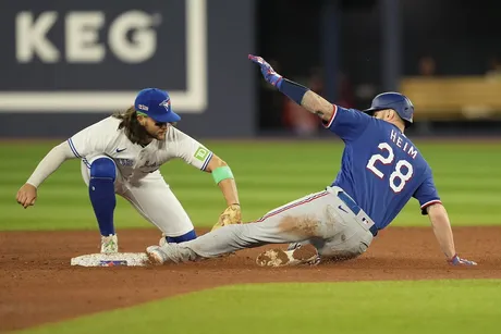 Heim hits grand slam as Rangers dump Jays 10-4 in opener of key