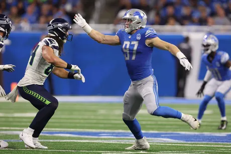 Malcolm Rodriguez and Jack Campbell of the Detroit Lions tackle