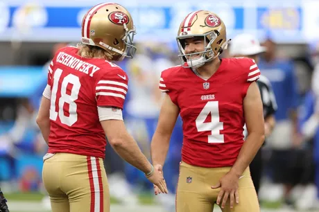 Punter (18) Mitch Wishnowsky of the San Francisco 49ers punts against the  Los Angeles Rams in