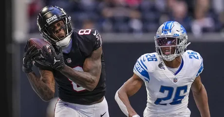 Malcolm Rodriguez and Jack Campbell of the Detroit Lions tackle