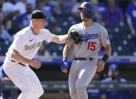 Rockies blast three homers, gain split with Dodgers