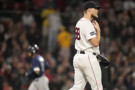 Fan throws ball on field and grazes pitcher George Kirby