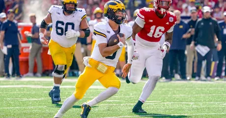 Michigan HC Jim Harbaugh and QB J.J. McCarthy talk to Allison